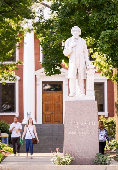 A statue of bet365官网 founder John Buchtel stands before Buchtel Hall