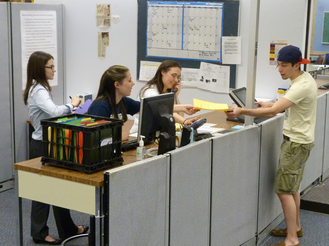 A student at a desk in the Bierce Writing Commons on the University of Akron campus