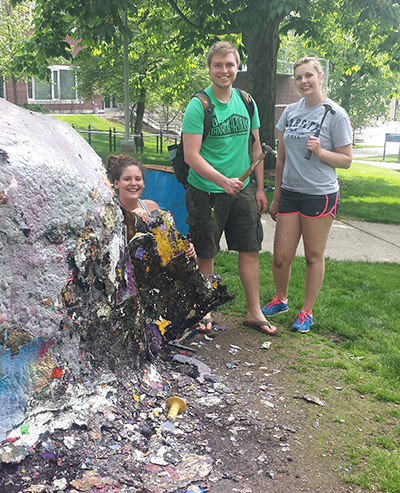Students cleak rock