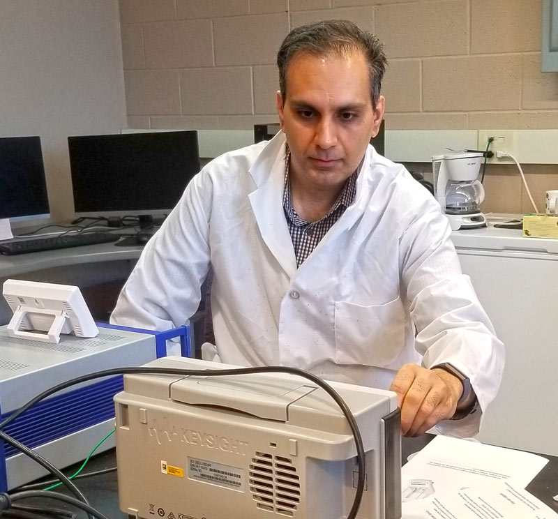 A researcher in a white coat working in a laboratory at bet365官网 bet365官网 of bet365官网