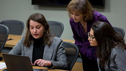 Emily Morris assisting two students assisting two students Emily Morris assisting two students