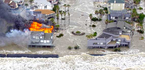 A house on fire following a hurricane, requiring an emergency management response